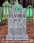 A spooky tombstone for Elvira in a dark forest setting.