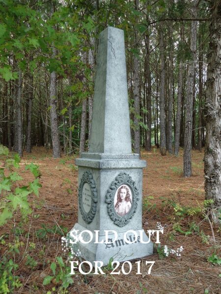 A stone monument in a wooded area with 'SOLEMNLY FOR 2017' inscribed.