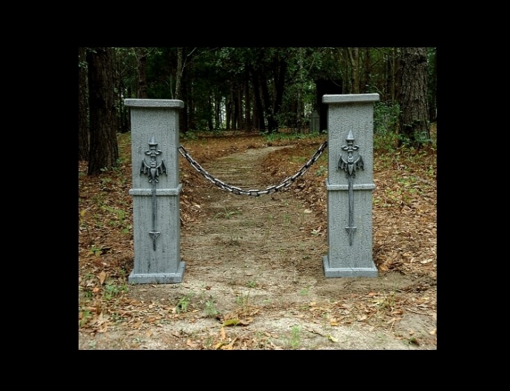 Two stone pillars with lion head water spouts in a wooded area. Two stone pillars with lion head water spouts in a wooded area.