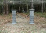 Brick mailbox with a ‘SOLD OUT’ sign in a wooded area.