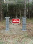 Brick mailbox with a ‘SOLD OUT’ sign in a wooded area.