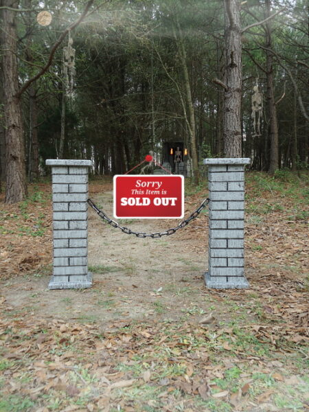 Brick mailbox with a 'SOLD OUT' sign in a wooded area.