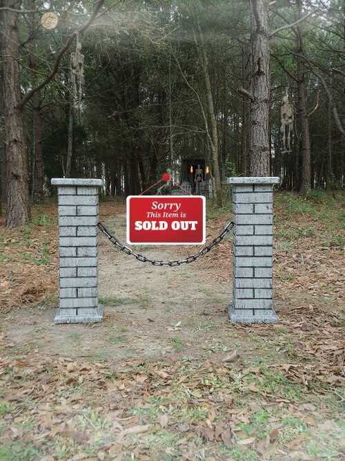 Brick mailbox with a 'SOLD OUT' sign in a wooded area. Brick mailbox with a 'SOLD OUT' sign in a wooded area.