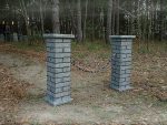Brick mailbox with a ‘SOLD OUT’ sign in a wooded area.