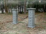 Brick mailbox with a ‘SOLD OUT’ sign in a wooded area.