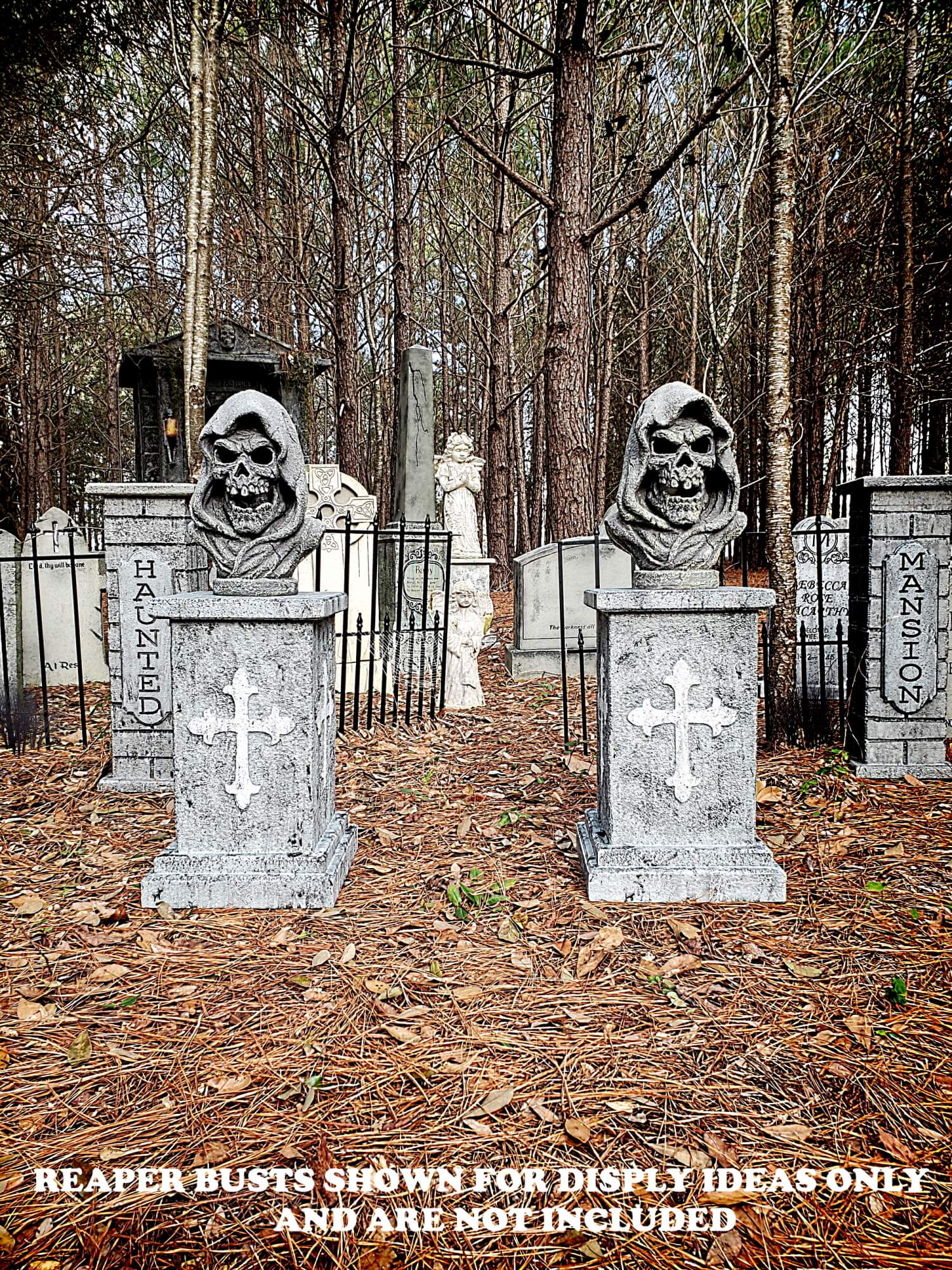 Two carved stone busts of men with beards in a forest cemetery. Two carved stone busts of men with beards in a forest cemetery.