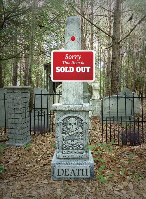 A graveyard tombstone with a 'Sold Out' sign about death. A graveyard tombstone with a 'Sold Out' sign about death.