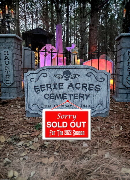 Creepy graveyard scene with colorful glowing tombstones and a sold-out sign.
