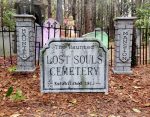 Entrance to a haunted-themed cemetery with a sold-out sign for a spooky event.