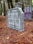 Entrance to a haunted-themed cemetery with a sold-out sign for a spooky event.