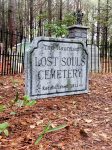 Entrance to a haunted-themed cemetery with a sold-out sign for a spooky event.