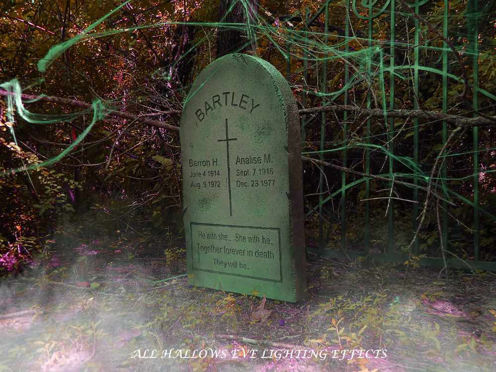Old tombstone in a misty graveyard with eerie lighting. Old tombstone in a misty graveyard with eerie lighting.