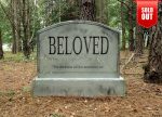 A gravestone engraved with ‘BELOVED’ in a forest setting.