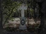 Eerie stone cross monument with a haunting face in the forest, marked as sold out.