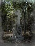 Eerie stone cross monument with a haunting face in the forest, marked as sold out.