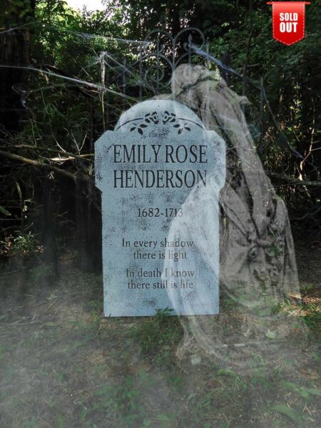 A gravestone with a ghostly figure in a misty forest setting.