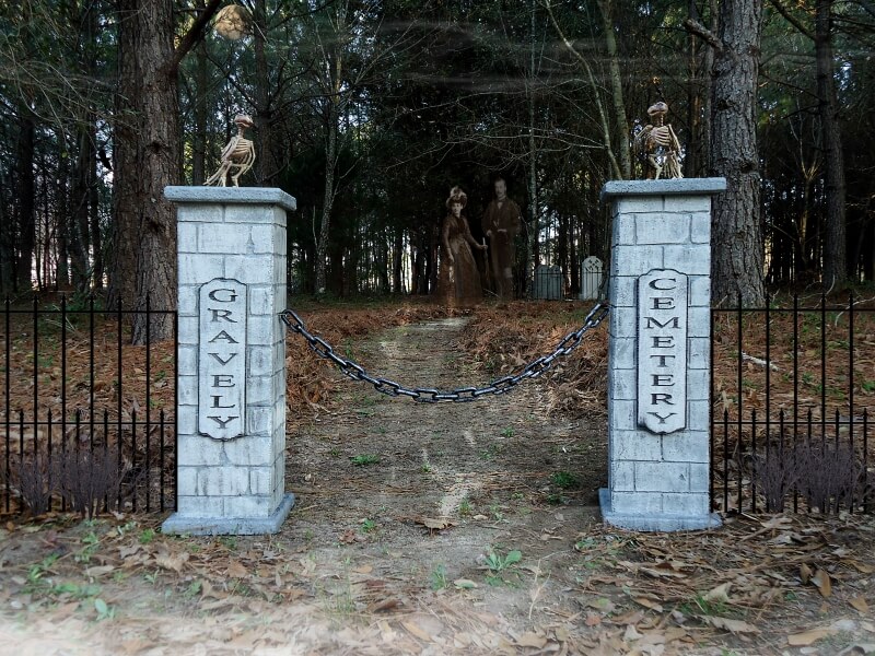 Old stone gate pillars marking the entrance to a wooded property. Old stone gate pillars marking the entrance to a wooded property.