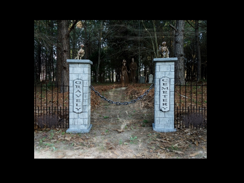 Two stone pillars at a forest entrance with a pathway beyond. Two stone pillars at a forest entrance with a pathway beyond.