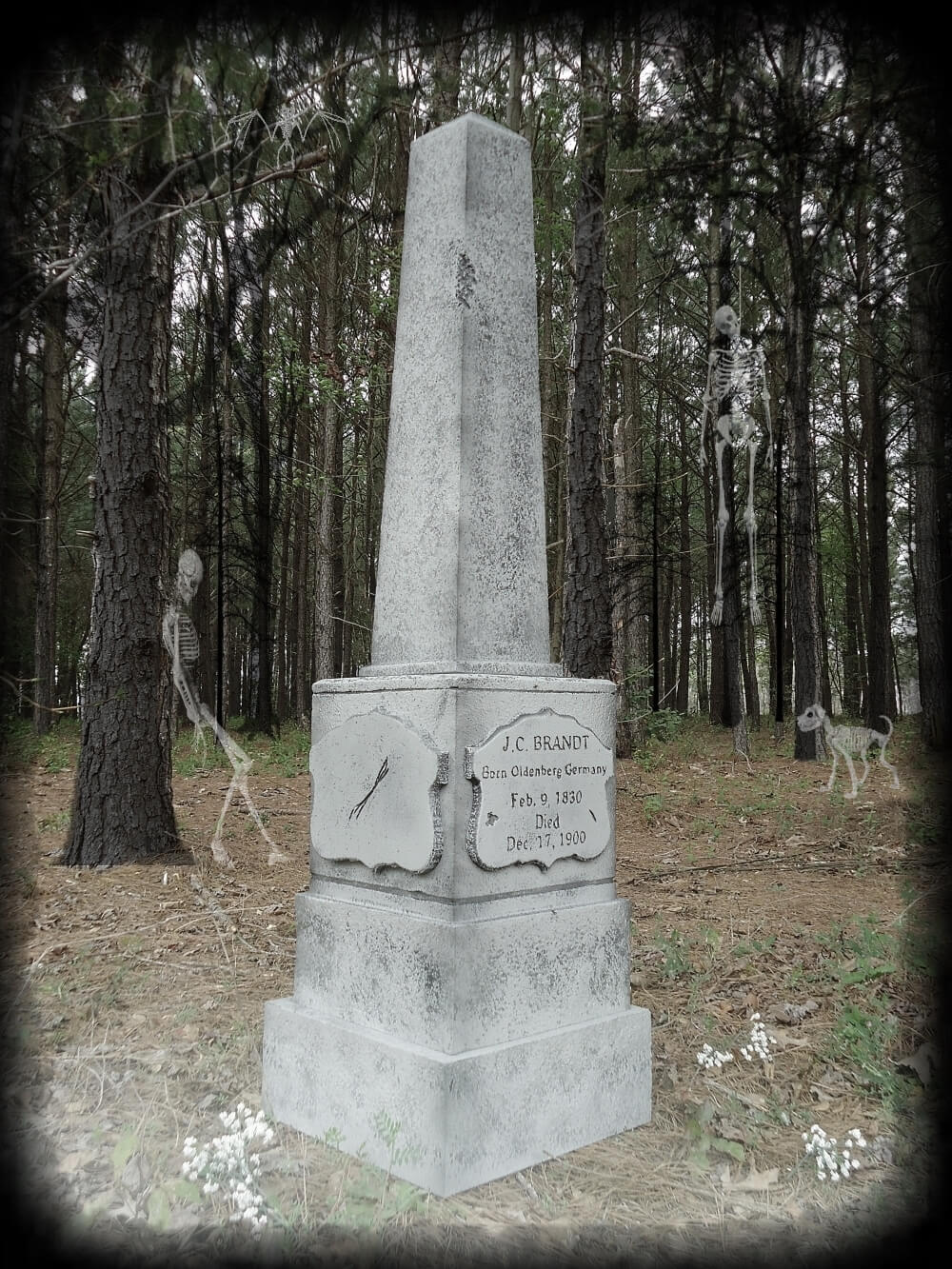 A stone monument with inscriptions stands in a forested area. A stone monument with inscriptions stands in a forested area.