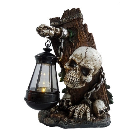 A spooky skeleton holding a lantern, sitting on a rock.