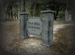 Entrance sign of Oak Hill Cemetery surrounded by trees.