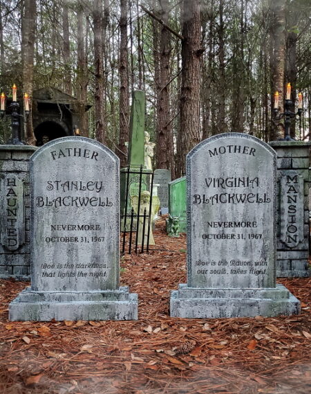Two old gravestones in a wooded cemetery.