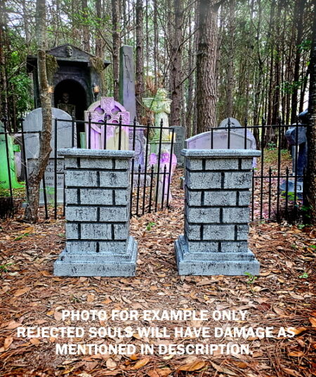 A fenced graveyard with decorated tombstones in a forested area.