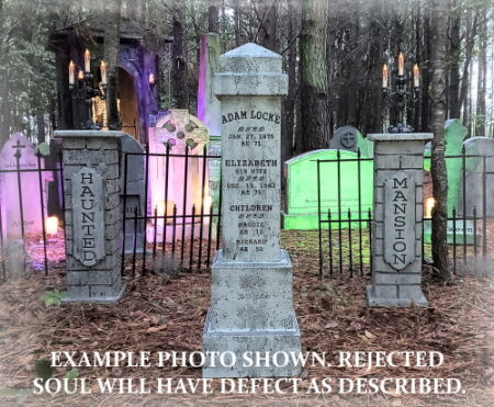 Colorful illuminated tombstones in a cemetery at night.