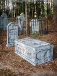 A spooky graveyard scene with tombstones and a coffin.