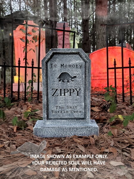 A gravestone with an inscription and a tree symbol in a graveyard.