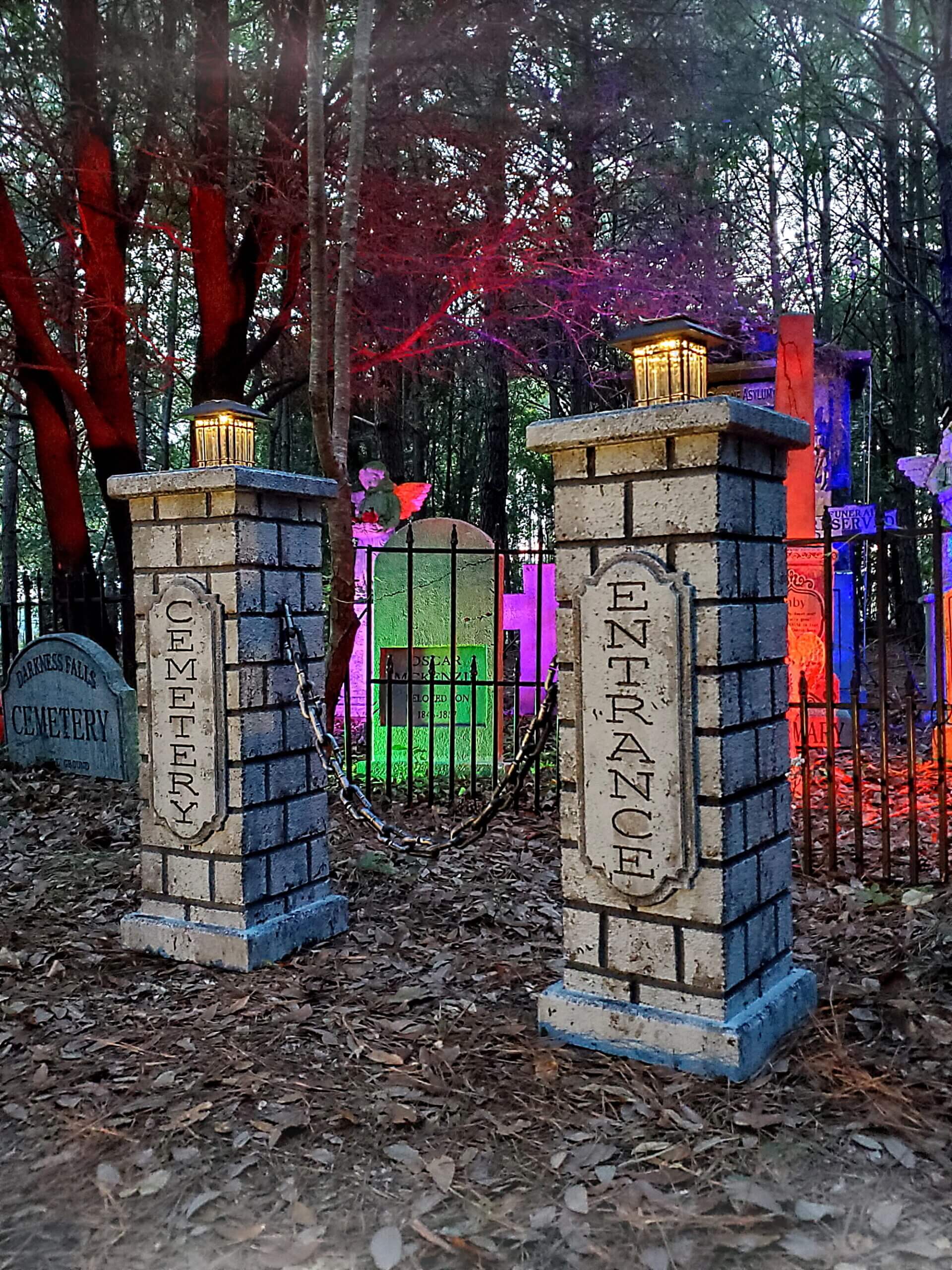A spooky Halloween scene with stone pillars, fog, and eerie lighting in a forest. A spooky Halloween scene with stone pillars, fog, and eerie lighting in a forest.